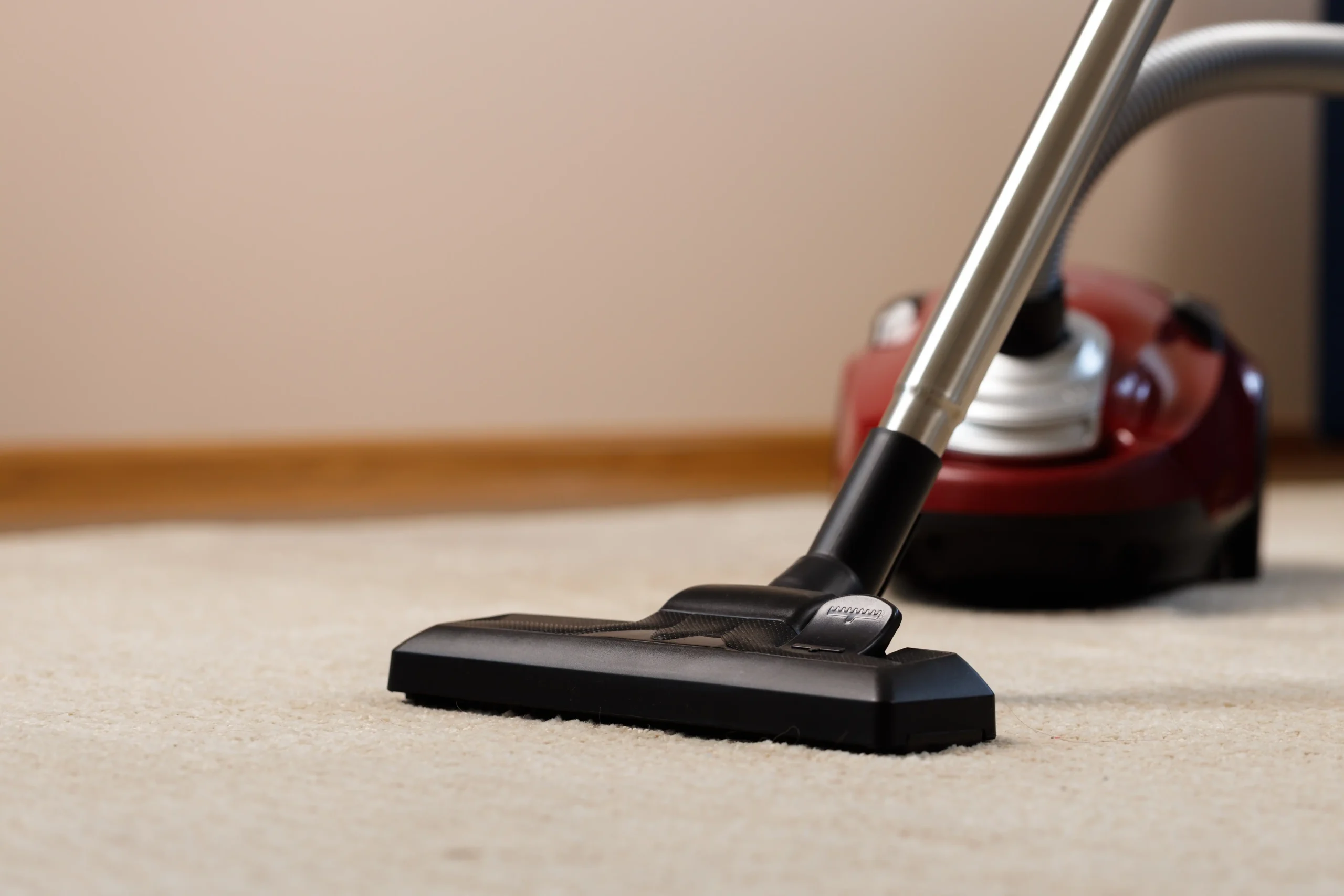 vacuum-cleaner-head-on-beige-carpet-cleaning-2026-03-23-23-49-23-utc